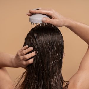medium-shot-woman-giving-herself-scalp-massage hair treatments
